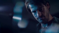 Man in motorcycle workshop looking at his bike Stock Footage