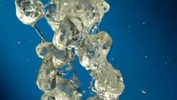 Beverage splash on blue background Stock Footage