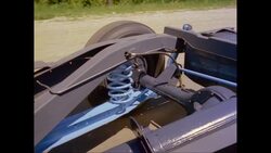 MS TS Moving vehicle on road, showing wheel and rear axle / United States Stock Footage