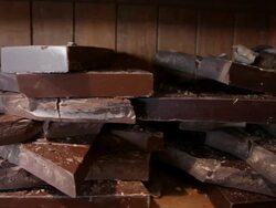 Slow dolly move across slabs of chocolate in Bruges, Belgium Stock Footage