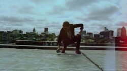Young street artist spraypaints concrete in Graffiti Park over Austin, Texas skyline Stock Footage