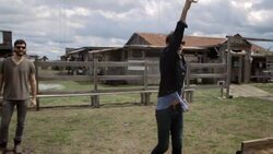 Young man tossing horseshoe looks disappointed when it misses the target Stock Footage