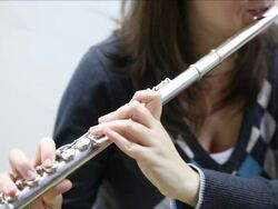 Young woman playing flute Stock Footage