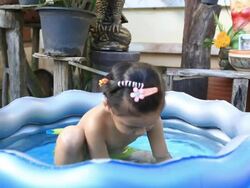 asia girl  playing in a paddling pool Stock Footage