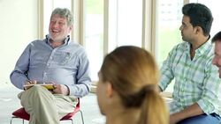 People talking in circle in group meeting Stock Footage