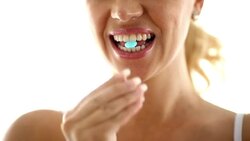 Woman biting a pill Stock Footage