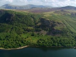 Aerial view of tree-covered fell on east side of Derwent Water in the Lake District / Cumbria, England Stock Footage