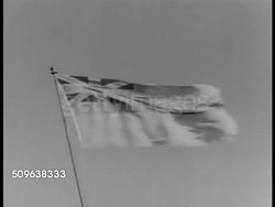 1941: ROYAL AUSTRALIAN NAVY: Two Battleships, Cruiser in harbor. MS Royal Navy flag flying on pole. Two Naval officer sitting at desk, talking. Sailors marching in parade formation. Poster: Ships of Royal Australian Navy. Sailor signaling. WWII Instructional Video