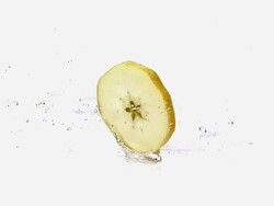 MS SLO MO Slice of apple rolling against white background / Vieux Pont, Normandy, France  Stock Footage