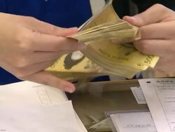 Bank clerk counting a fifty thousand won note Stock Footage
