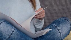 Graphic designer working at home, looking at blueprints Stock Footage