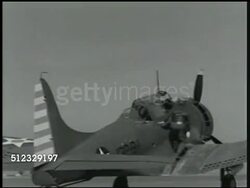 1942: U.S. MARINE CORPS: AIR SQUADRON: WS Ground crew loading bomb shell onto back of truck. MS Naval Air Force pilot climbing into cockpit of fighter airplane (variation of Curtiss P-36 Hawk, unconfirmed). (PAN) WS Two airplanes taking off on runway. Instructional Video
