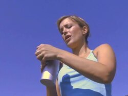 Woman drinking water outdoors, UK Stock Footage