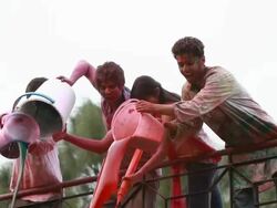 Group of young people falling water from roof top Stock Footage