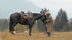 SLO MO DS Cowboy petting his horse Stock Footage