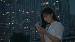 Asian businesswoman using smart phone at city night Stock Footage