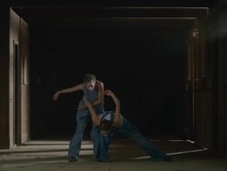 two dancers running in from darkness and then dancing together Stock Footage
