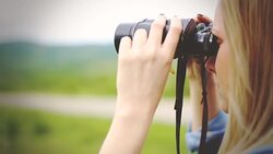 woman traveler looking through binoculars Stock Footage