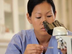 "medical lab technician looking in microscope/Richmond,Virginia, USA" Stock Footage