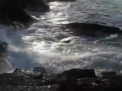 CU shot of ocean waves crashing on rocks at sunset / Portland, ME, United States Stock Footage