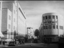 1952: JERUSALEM, ISRAEL: XHA WS City. VS City buildings, people walking sidewalks, car driving down street. VS Damaged three story building, partial wall collapsed w/ chunks of concrete FG. Instructional Video