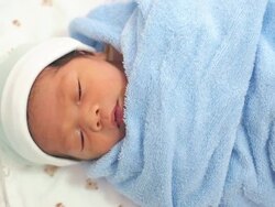 Newborn baby in blue towel Stock Footage