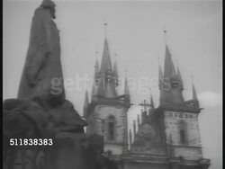 1938: PRAGUE, CZECHOSLOVAKIA: TU Church of Our Lady in front of Tyn w/ partial statue of Jan hus FG. Crowded sidewalk. Czech Republic. Instructional Video