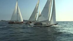 American flags wave in the breeze behind three sailboats sailing together across Narragansett Bay. Stock Footage