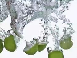 CU SLO MO Green lemon(citrus aurantifolia) cutted fruits entering in water / Vieux Pont, Normandy, France Stock Footage