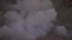 A young man jumps through the smoke after fireworks explode. Stock Footage