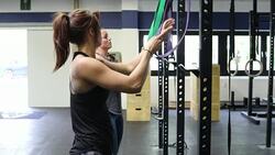 Dedicated women pulling resistance bands in gym Stock Footage