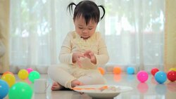 Little asian girl eating rice in home Stock Footage