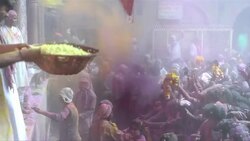 CLEAN: Indian Hindu devotees throw colours during Holi celebrations News Clip