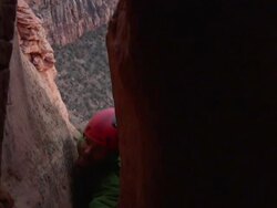 MS CU Camera in crack on climber appears and tries to ascend difficult terrain and Climber high above ground / Zion, UT, USA Stock Footage