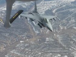 MS F-16 fighter jet approaching to refuel in mid-air, Colorado Rockies, Colorado, USA Stock Footage