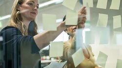 Writing notes for the new business strategy plan Stock Footage