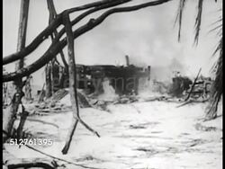 1943: BETIO, TARAWA: POST FIGHTING: (Low contrast, very smoky) PAN Destruction on island. VS Building burning, tank moving, Marines walking.  (Time-Life War Correspondant Robert Sherrod describes) WWII, World War II. Instructional Video