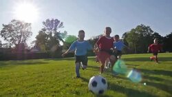 Children playing soccer Stock Footage