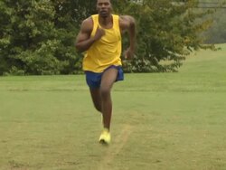 Male Athlete Runs Past Camera Stock Footage
