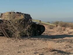 WS PAN Broken down tank in the desert Stock Footage