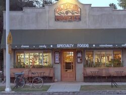 TD exterior establishing shot of neighborhood market and coffee house in historic building from 1920s / Redlands, California, USA Stock Footage