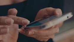 Close up of a woman's hand holing and using a mobile phone Stock Footage