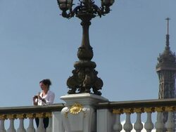 MS Woman standing on bridge and taking picture / Paris, Ile-de-France, France    Stock Footage