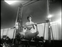 Women exercise on weight-benches, stationary bikes and rowing machines at a gym in the 1960's. News Clip