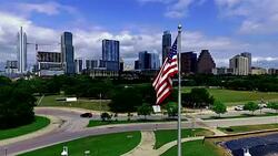 American Flag in Front of Austin Texas Capital City Downtown Skyline Stock Footage