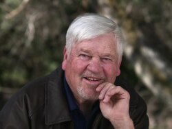Older man with hand on chin cracking a smile. Stock Footage