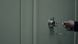 Bank.Security opening the door leading into room with deposit boxes Stock Footage