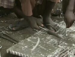 CU Shot of man sitting and recovering copper pipe from old heat exchangers / Lagos, Nigeria Stock Footage