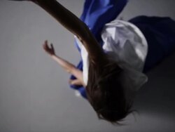 woman moving with blue silk fabric draped around her  Stock Footage