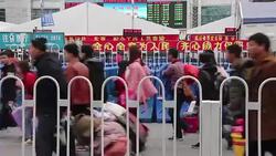 CLEAN : Stranded Lunar New Year travellers crowd Chinese rail station News Clip